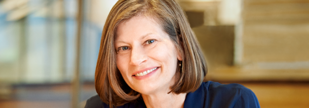 photograph of Alyson Steele FAIA in the foreground with stairs in the background